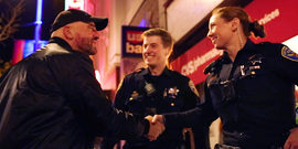 SFPD Female and Male Officer Shaking Hands with Man On Street